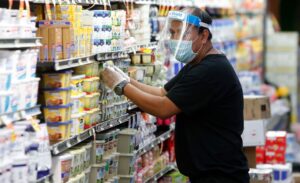 Grocery Store Employee Stocking Butter