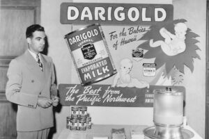 Vintage image of man with Darigold evaporated milk display