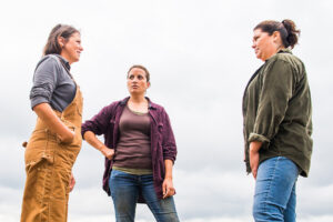 Three female farmers talking in a circle