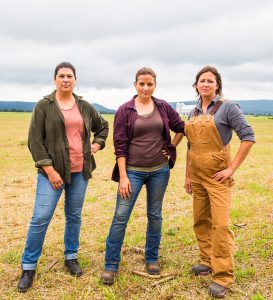 Female farmers standing next to each other