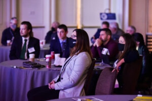 Woman at NMPF Annual Meeting Table in Mask