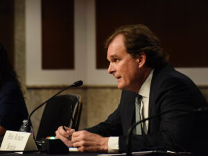 Hon. Robert Bonnie speaks into microphone