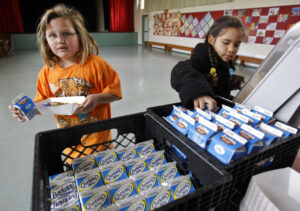 Children pick up school lunch milk
