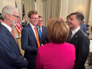 NMPF CEO smiles with group in Capitol Hill