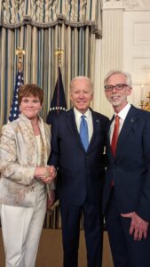 Jim Mulhern, NMPF CEO, poses with President Biden
